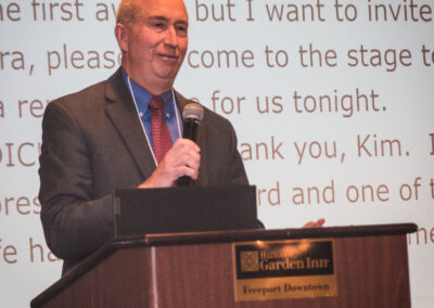 Dick O'Meara speaks behind a podium.