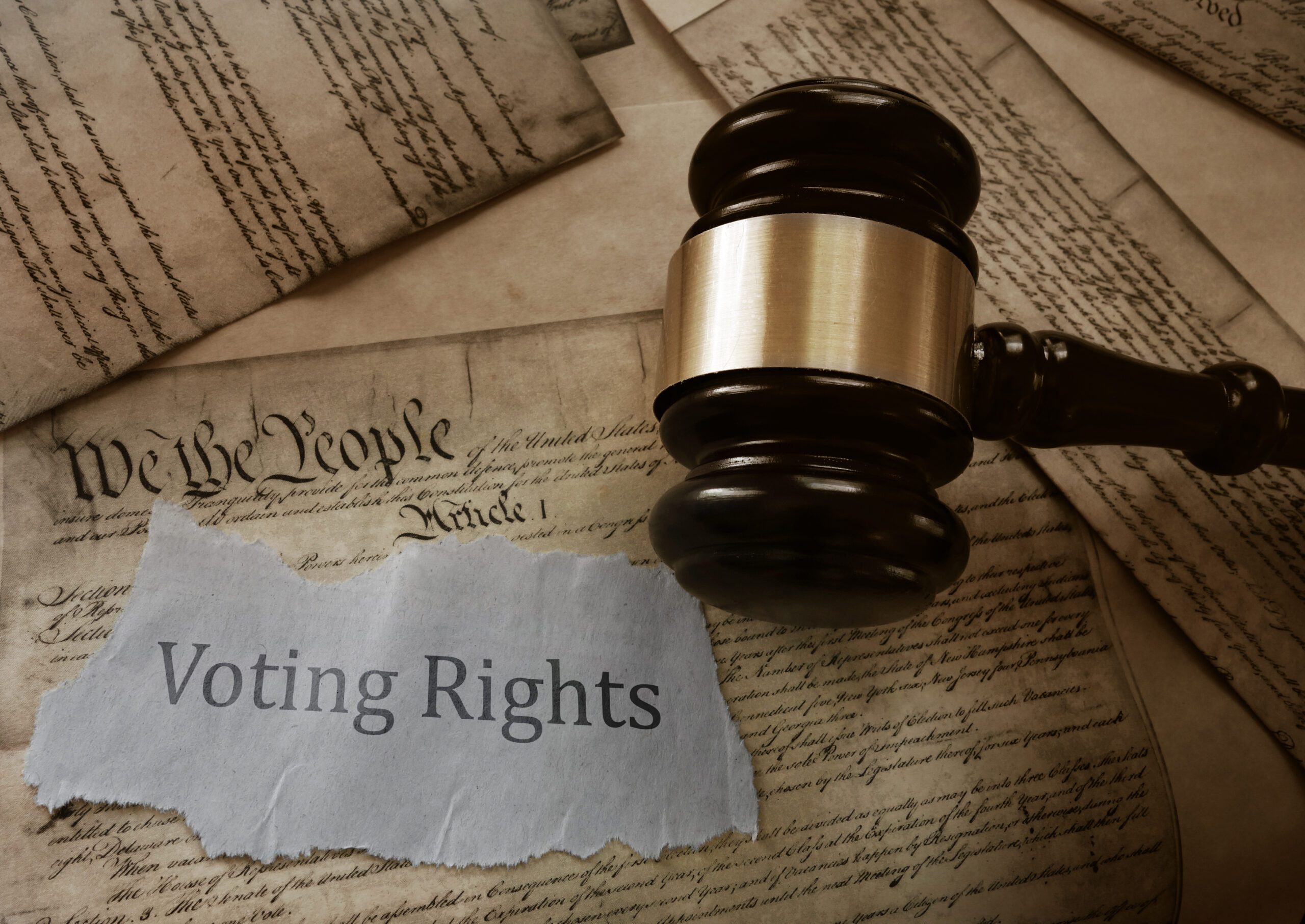 Voting Rights news headline on a copy of the US Constitution with gavel