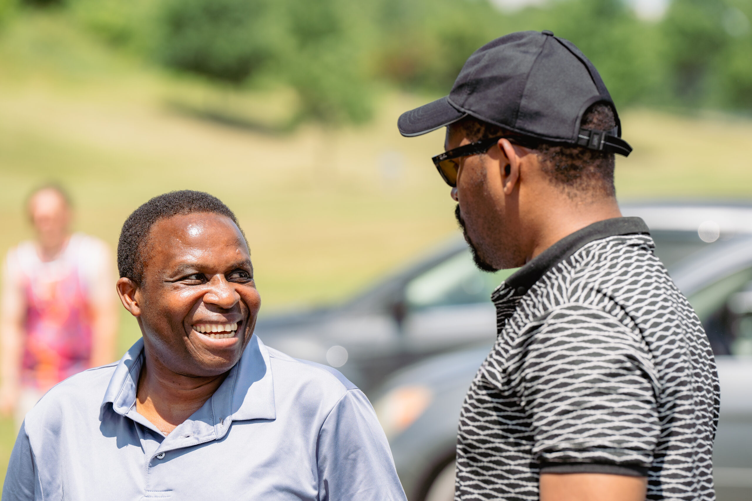 Two black men talk to each other.