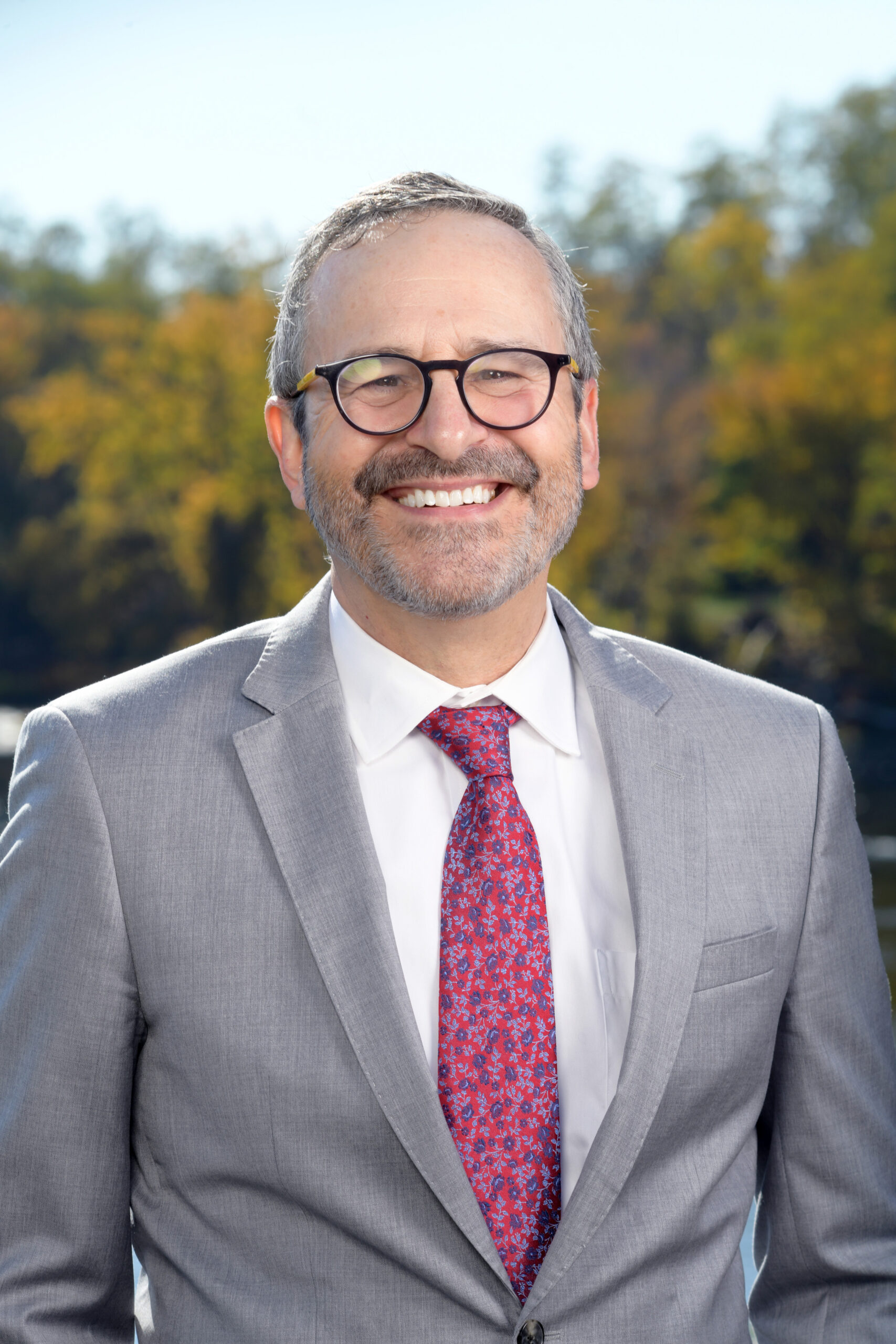 David Webbert, a white man with glasses and gray hair. He wears a gray suit and a red tie.