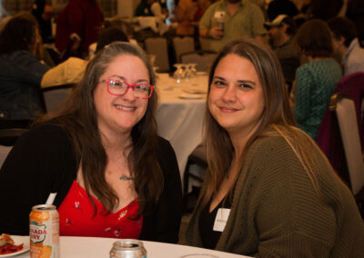 Two women smile at the DRM celebration