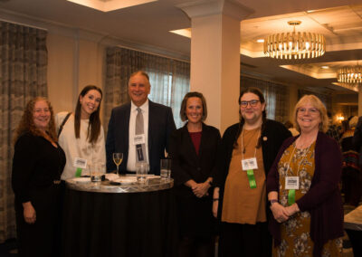 A group of six staff at the DRM celebration.