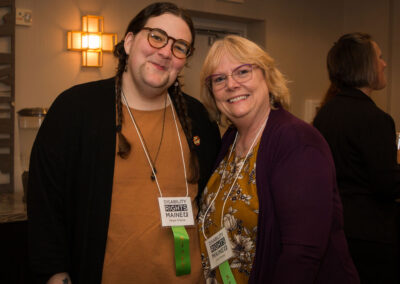 Two staff smile at the DRM celebration.