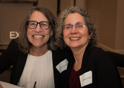 Two people smile at DRM celebration.