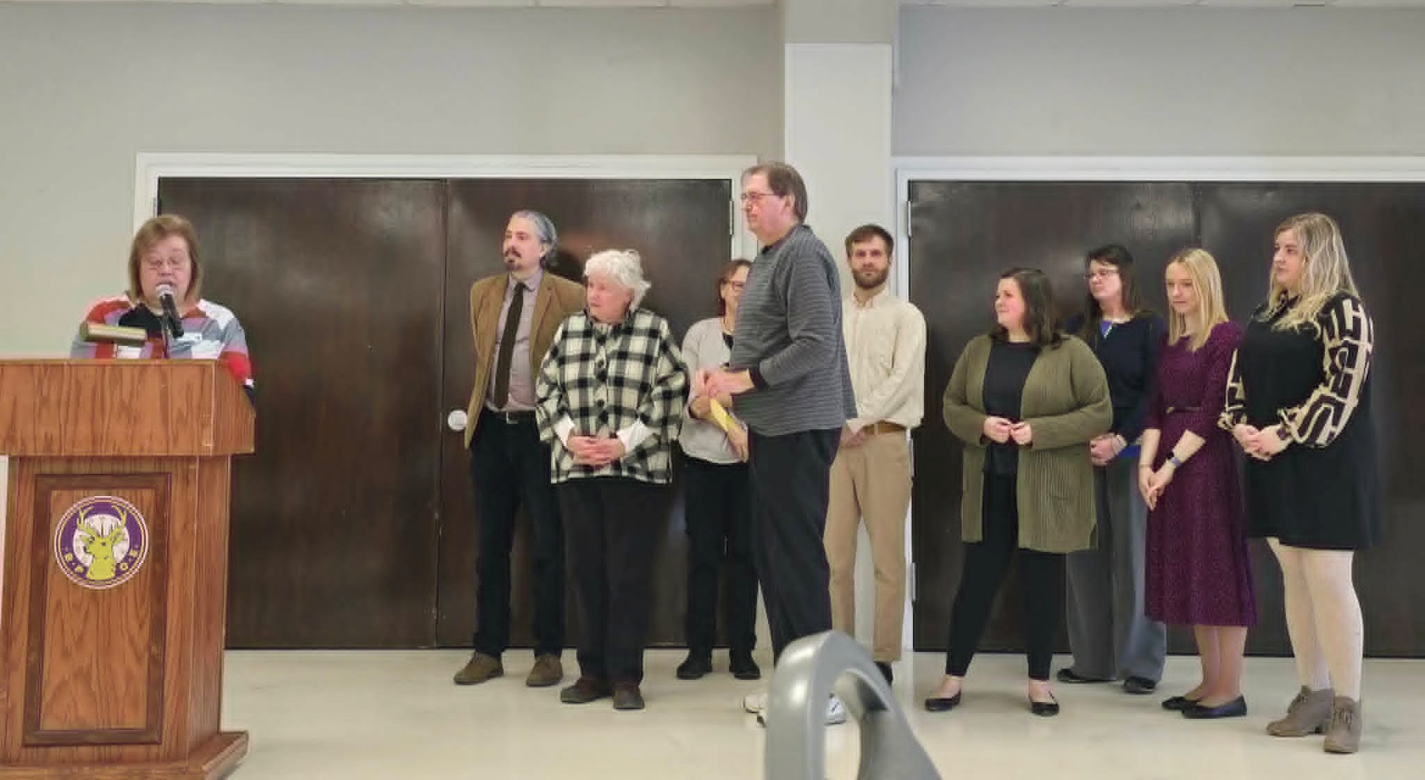 The DRM Mental Health Advocacy Team accepts an award from CCSM.