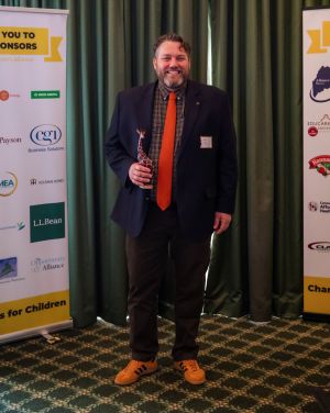 Managing Attorney Atlee Reilly accepts an award from MCA